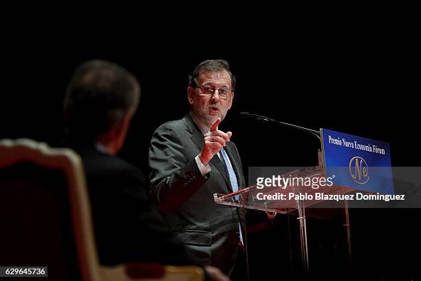 Spanish Prime Minister Mariano Rajoy gestures towards President of Colombia Juan Manuel Santos during his speech at the Premio Nueva Economia Forum...