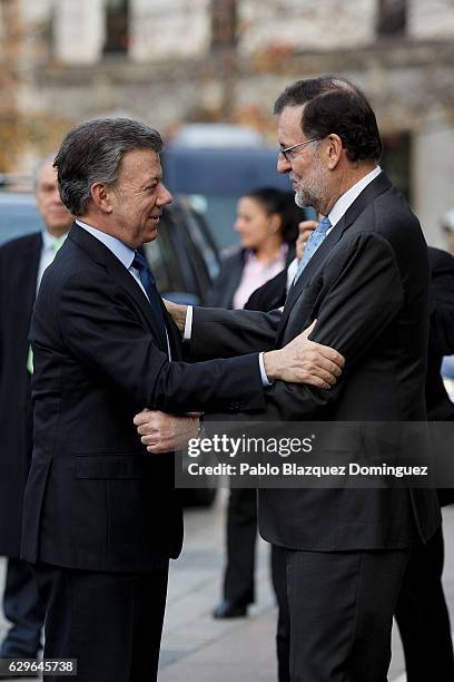 President of Colombia Juan Manuel Santos and Spanish Prime Minister Mariano Rajoy congratulate each other as they arrive at the Premio Nueva Economia...