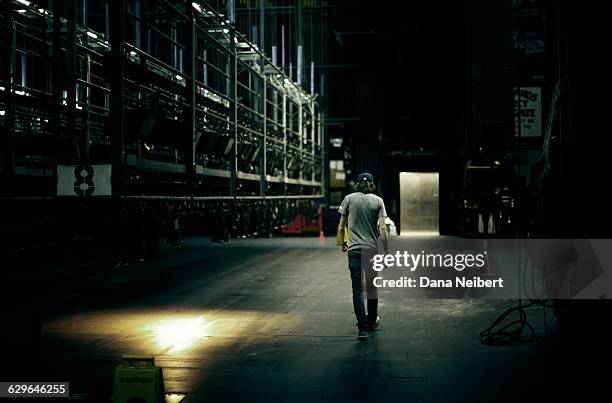 a roadie walks back stage - man backstage stock pictures, royalty-free photos & images