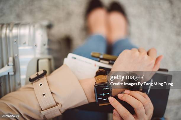 a closeup of lady's hand using smart watch - airport from above stock pictures, royalty-free photos & images