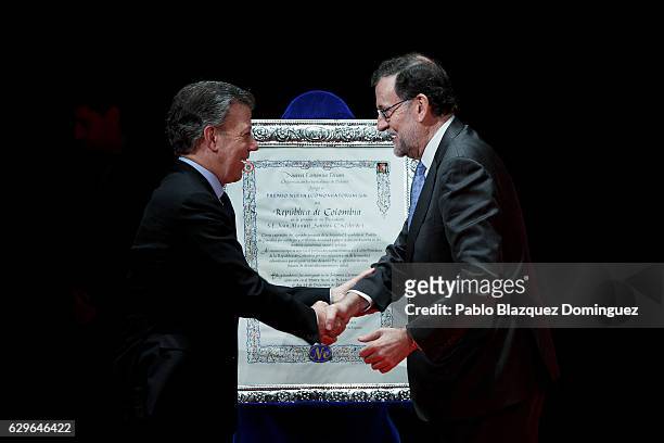 Spanish Prime Minister Mariano Rajoy congratulates to President of Colombia Juan Manuel Santos as he gives him the Premio Nueva Economia Forum 2016...
