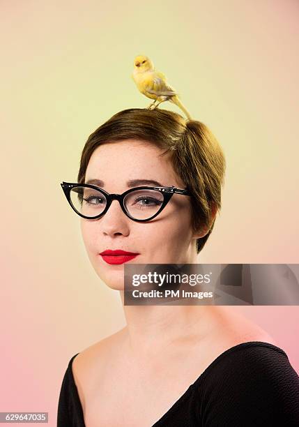 girl and her canary, portrait - cats eye glasses photos et images de collection