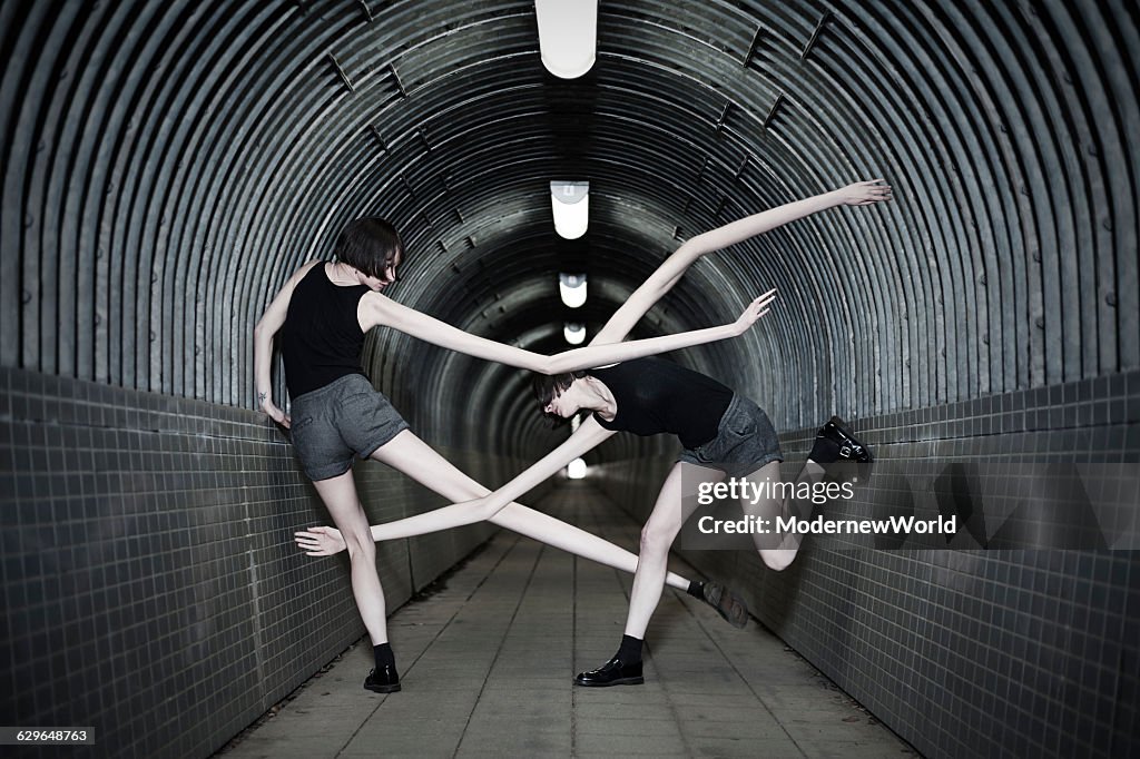 Girls of long arm and legs fighting in the tunnel