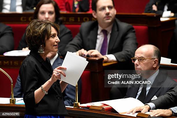 French Minister for Social Affairs and Health Marisol Touraine speaks during a session of questions to the government next to French Prime Minister...