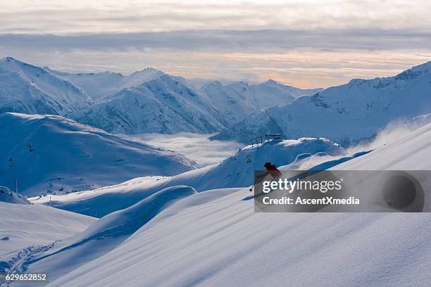 female athlete making a powder turn - whistler mountain stockfoto's en -beelden