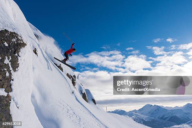 female athlete jumping off a cliff - whistler-blackcomb-ski-resort stock pictures, royalty-free photos & images