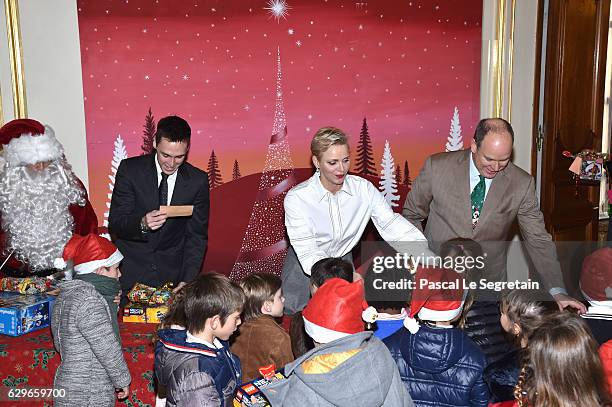 Louis Ducruet, Princess Charlene Of Monaco and Prince Albert II of Monaco attend the annual Christmas gifts distribution at Monaco Palace on December...