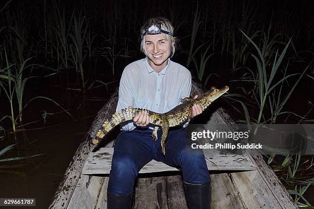 girl exploring jungle river night holding cayman