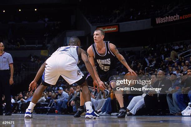 Jason Williams of the Sacramento Kings dribbles the ball as Chris Whitney of the Washington Wizards gaurds him during the game at the MCI Center in...