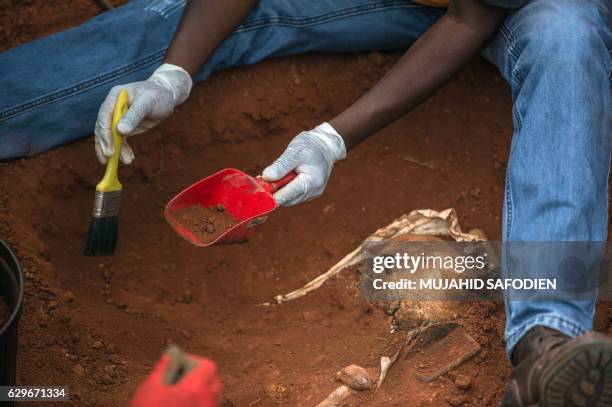 Graphic content / A person works on the exhumation of 14 bodies of political prisoners executed in 1964 during the apartheid, on December 14, 2016 at...