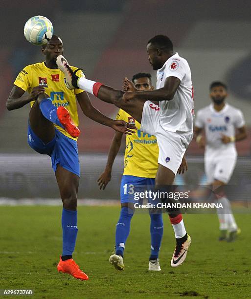 Delhi Dynamos FC forward richard Gadze vies for the ball with Kerala Blasters FC's midfielder Azarack Mahamat during the second leg of the second...