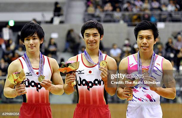 Second place Ryohei Kato, first place Kenzo Shirai of Japan and third place Tuan Dat Nguyen of Vietnam pose on the podium at the medal ceremony for...