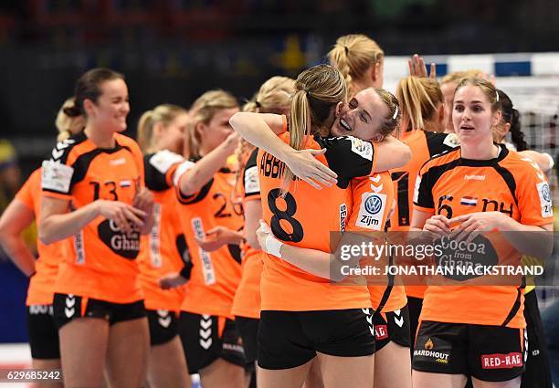 Netherlands' players celebrate their victory after the Women's European Handball Championship Group I match between Spain and Netherlands in...