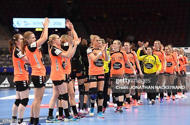 Netherlands' players celebrate their victory after the Women's European Handball Championship Group I match between Spain and Netherlands in...