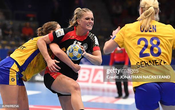 Sweden's Anna Lagerquist and Germany's Anne Hubinger vie for the ball during the Women's European Handball Championship Group I match between Sweden...