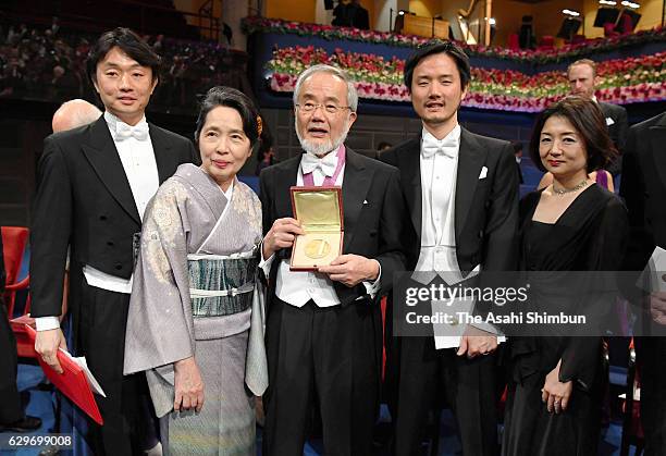 Nobel Prize in Physiology or Medicine laureate Yoshinori Ohsumi and his wife Mariko pose for photographs after the Nobel Prize Awards Ceremony at...