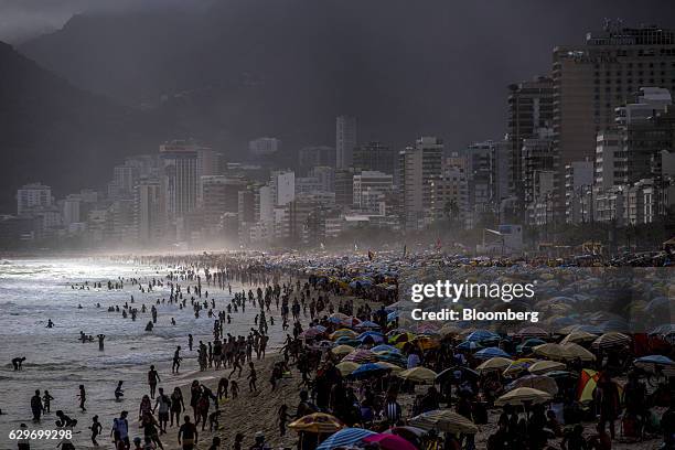 Bloomberg Best of the Year 2016: Thousands gather on Ipanema Beach in Rio de Janeiro, Brazil, on Tuesday, Jan. 5, 2016. A strong U.S. Dollar, lower...