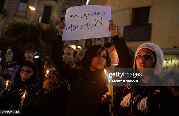 People hold candles during a commemoration for victims of a Sunday bombing at a Coptic cathedral in Cairo, Egypt on December 14, 2016. Twenty five...