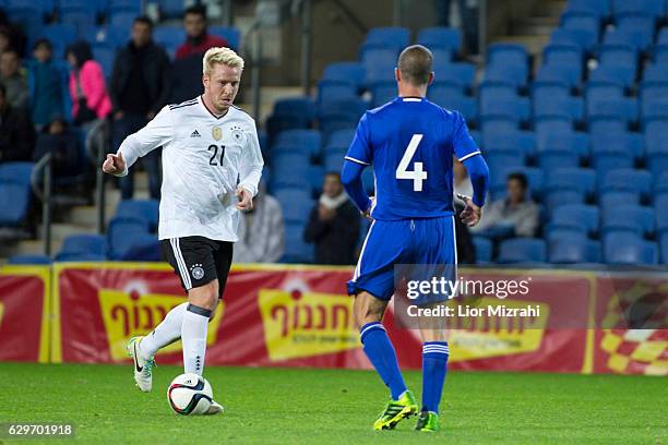Mike Hanke of Germany challenges Amir Schelach of Israel during an Allstars Israel v DFB All Stars Friendly Match on December 14, 2016 in Netanya,...