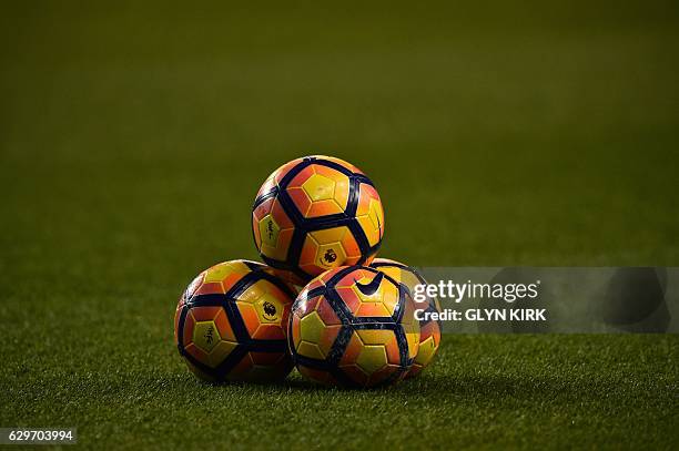 Footballs sit stacked on the pitch ahead of the English Premier League football match between Tottenham Hotspur and Hull City at White Hart Lane in...