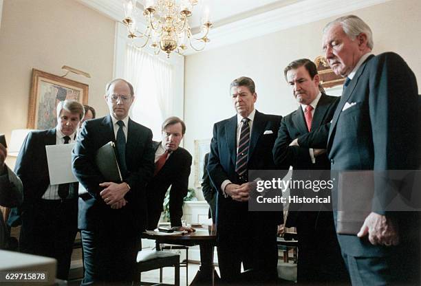 President Ronald Reagan and members of his staff view the Challenger explosion from the White House.