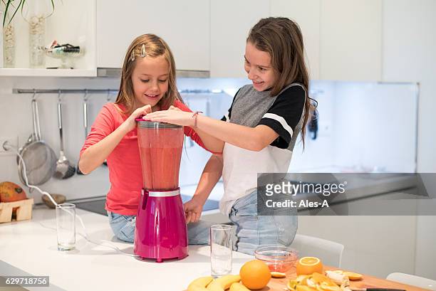 girls preparing a smoothie - mixer stock pictures, royalty-free photos & images