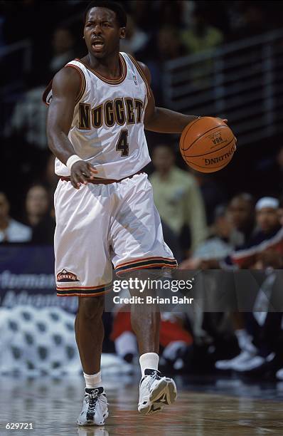 Anthony Goldwire of the Denver Nuggets dribbles the ball during the game against the New York Knicks at the Pepsi Center in Denver, Colorado. The...