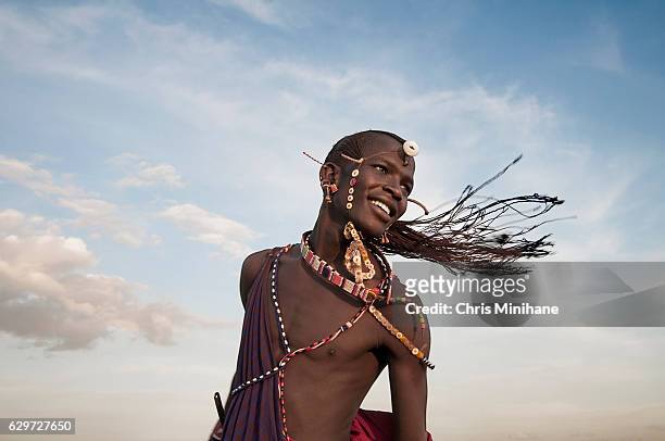 maasai warrior tribesman with braided hair flying - アフリカ 原住民 ストックフォトと画像