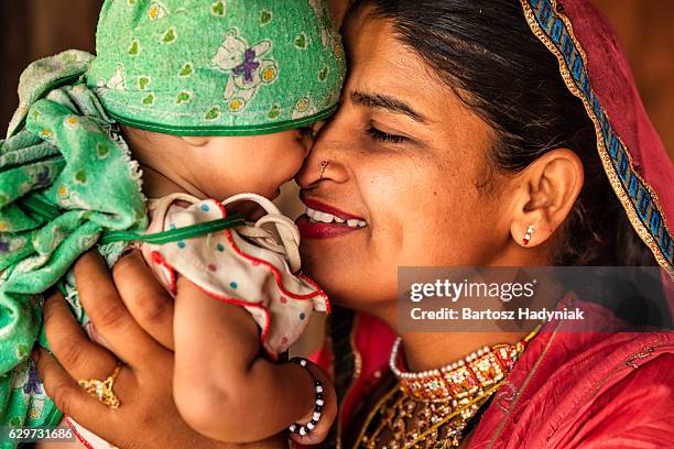 indian woman with her newborn daughter, bishnoi village - mother and daughter kissing stock pictures, royalty-free photos & images
