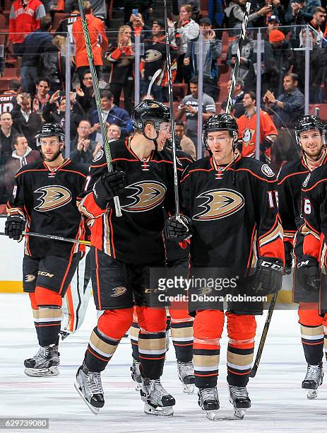 Nick Ritchie and Ryan Garbutt of the Anaheim Ducks talk while celebrating a shootout win over Carolina Hurricanes after the game at Honda Center on...
