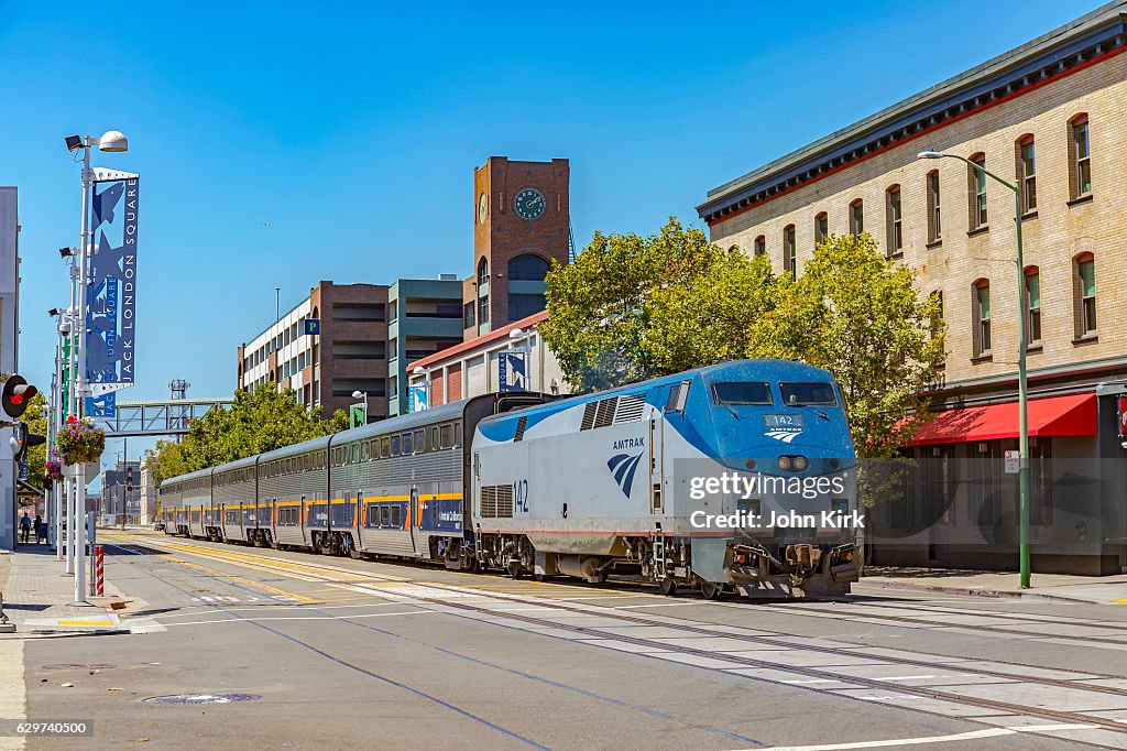 Amtrak train on street, Jack London Square, Oakland, California