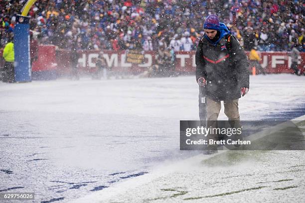 Field crews remove snow from the field during the first quarter between the Buffalo Bills and the Pittsburgh Steelers on December 11, 2016 at New Era...