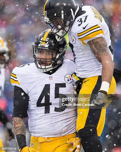 Jordan Dangerfield congratulates Roosevelt Nix-Jones of the Pittsburgh Steelers on a defensive stop during the first half against the Buffalo Bills...