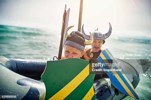 kids playing vikings at sea on a boat - snäckor bildbanksfoton och bilder