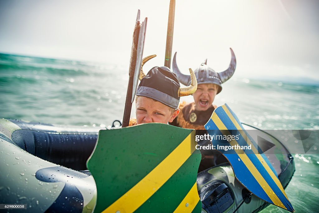 Kids playing vikings at sea on a boat
