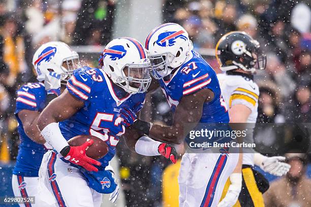 James Ihedigbo congratulates Zach Brown of the Buffalo Bills for a turnover during the second half against the Pittsburgh Steelers on December 11,...