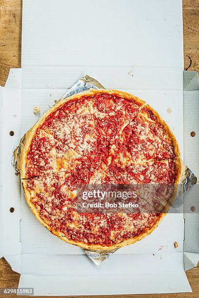 chicago deep dish pizza on wooden table - deep dish pizza stock pictures, royalty-free photos & images