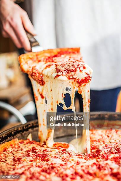 slice of chicago deep dish pizza - pizza temptation stock pictures, royalty-free photos & images