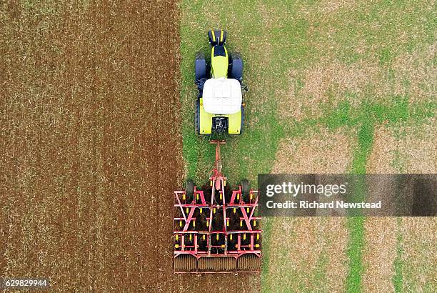 tractor ploughing field - plough stock pictures, royalty-free photos & images