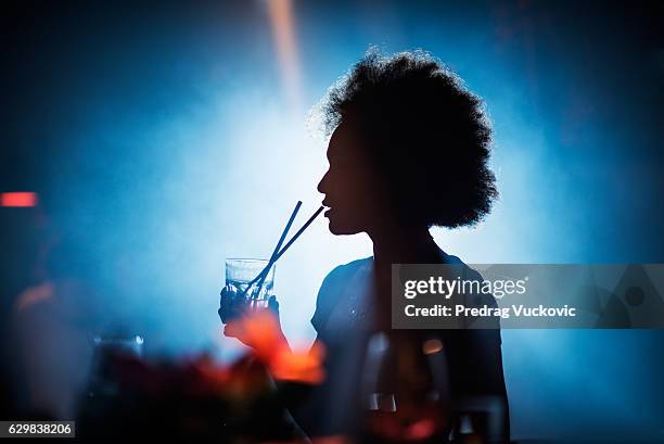 woman drinking in the bar - disco dancing stock pictures, royalty-free photos & images