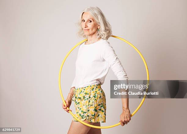 lady looking young - hula hoop studio stock pictures, royalty-free photos & images