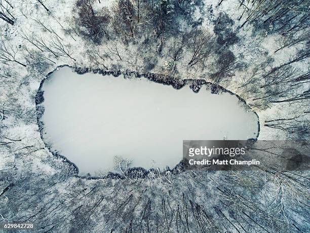 aerial of frozen pond with first ice during winter - frozen lake stock pictures, royalty-free photos & images