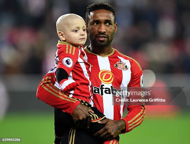 Bradley Lowrey and Jermain Defoe of Sunderland walk into the pitch prior to the Premier League match between Sunderland and Chelsea at Stadium of...