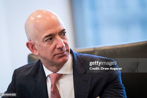 Jeff Bezos, chief executive officer of Amazon, listens during a meeting of technology executives and President-elect Donald Trump at Trump Tower,...