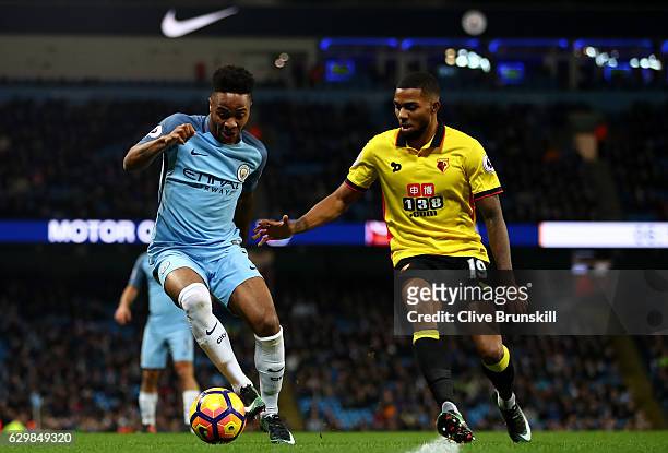 Raheem Sterling of Manchester City and Jerome Sinclair of Watford compete for the ball during the Premier League match between Manchester City and...