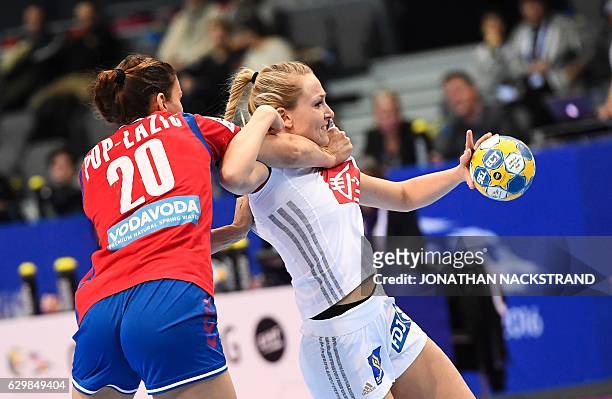 Serbia's Sladana Pop Lazic vies with France's Manon Houette during the Women's European Handball Championship Group I match between Serbia and France...