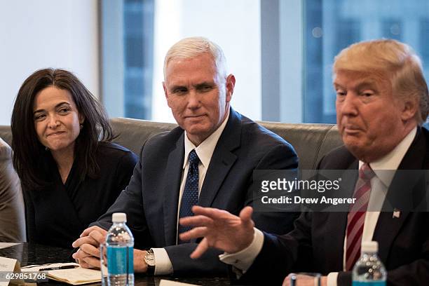 Sheryl Sandberg, chief operating officer of Facebook, and Vice President-elect Mike Pence listen as President-elect Donald Trump speaks during a...