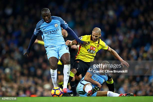 Yaya Toure of Manchester City and Adlene Guedioura of Watford and Fernando of Manchester City battle for possession during the Premier League match...