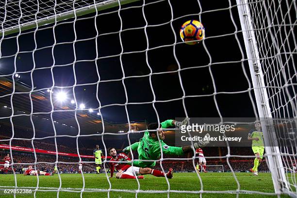 Adam Lallana of Liverpool scores his team's third goal past Victor Valdes of Middlesbrough during the Premier League match between Middlesbrough and...