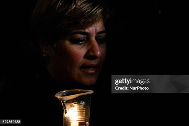 People hold candles during a vigil for victims of a Sunday bombing at a Coptic cathedral, in downtown Cairo, Egypt, Wednesday, Dec. 14, 2016. Twenty...